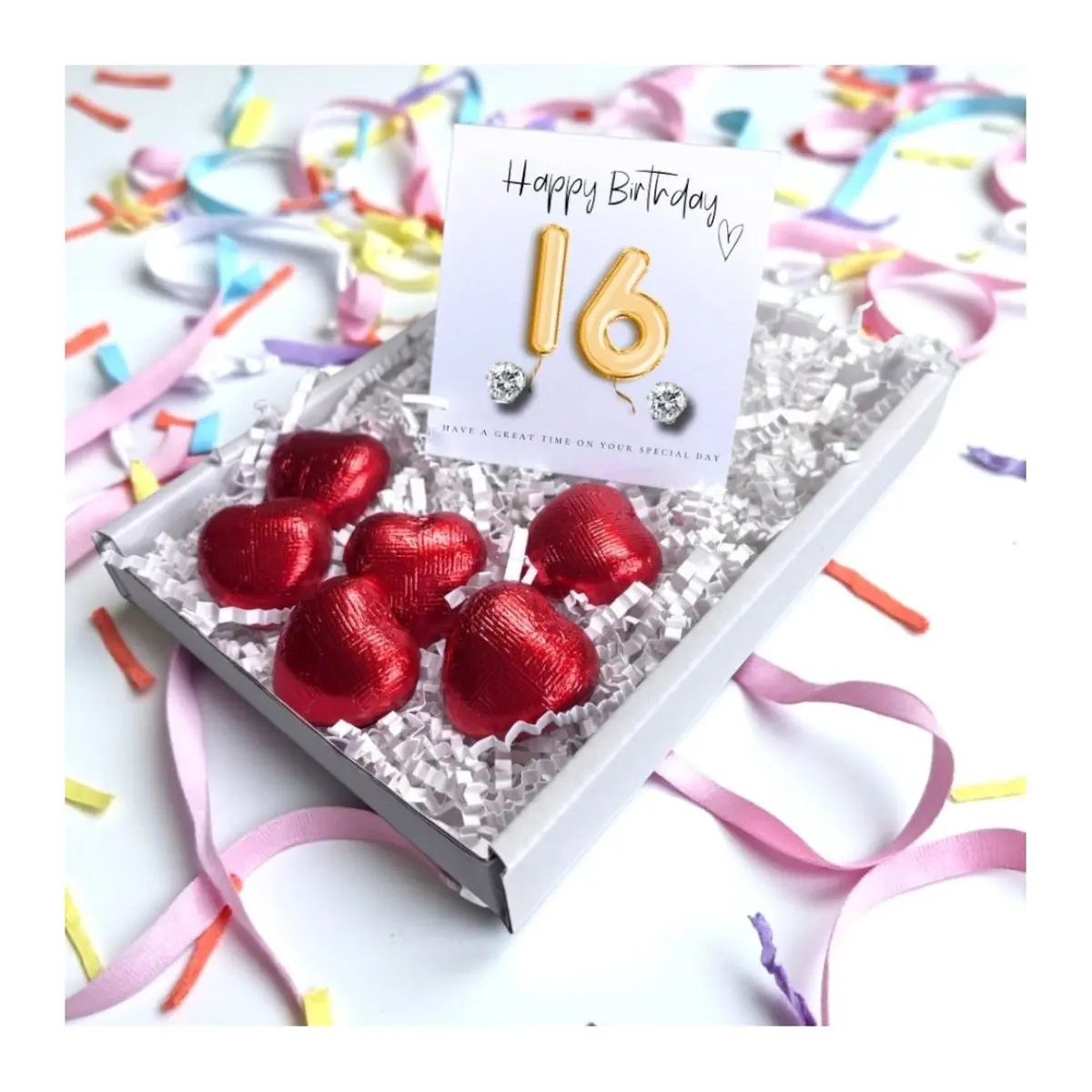 Cubic zirconia stud earrings and red foiled chocolate hearts with a gold balloons card