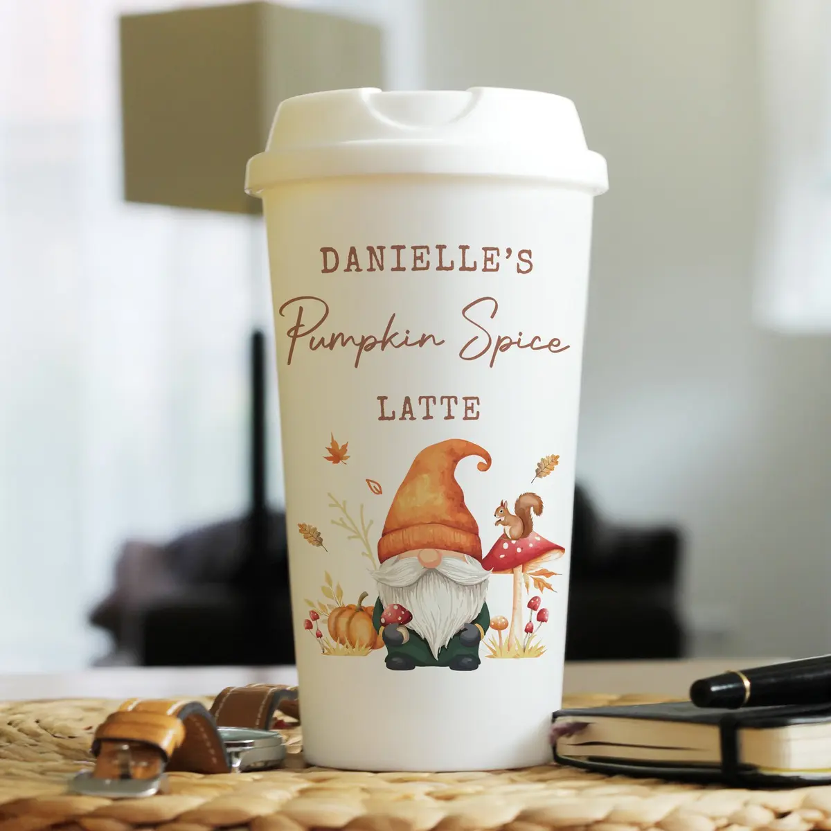 Autumn gonk travel cup with a screw-on lid and three lines of text