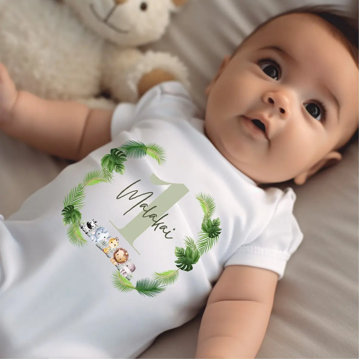 Green personalised baby grow with a jungle animals design and a name