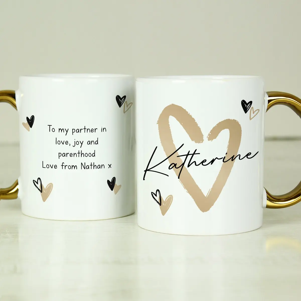Personalised ceramic mug with a gold handle and a gold heart design