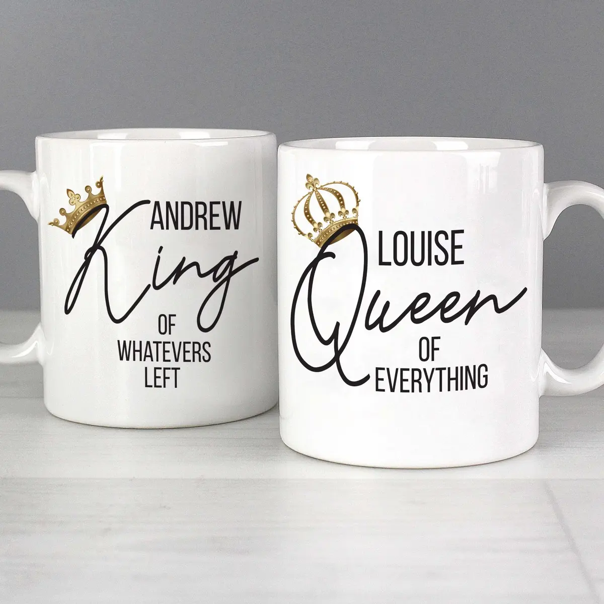 Two ceramic mugs reading King of whatevers left and Queen of everything