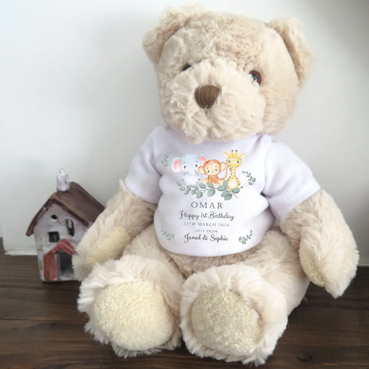 Luxury teddy bear in a T-shirt with an elephant, monkey and giraffe design