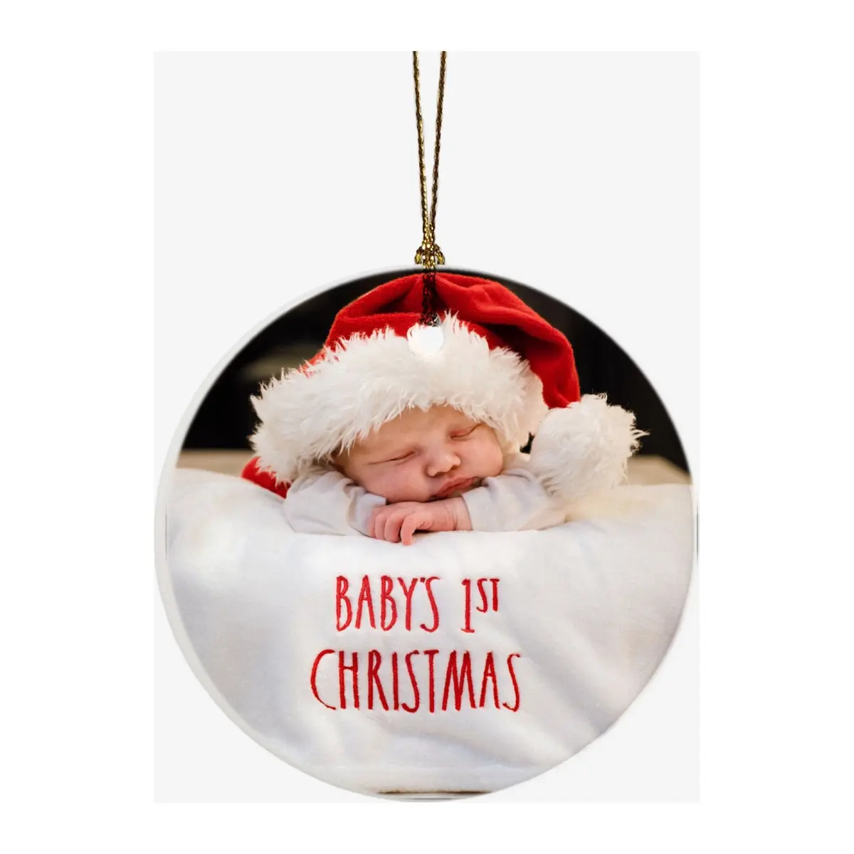 Round white ceramic bauble printed with a sleeping baby in a Santa hat