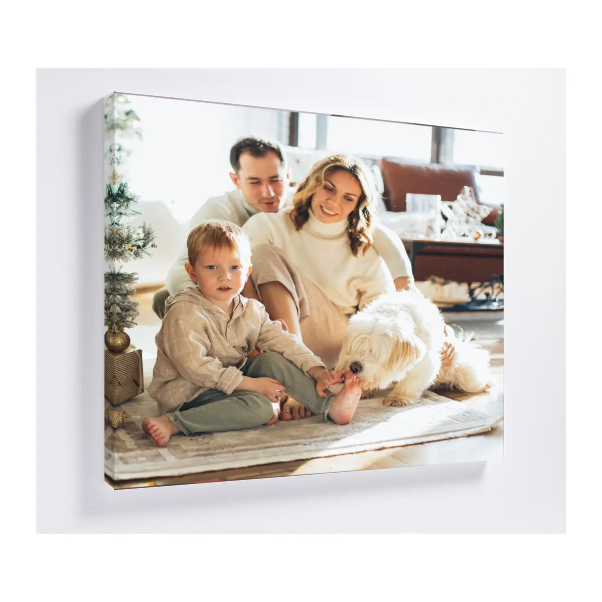 Square canvas on a wall printed with a family photo by a Christmas tree