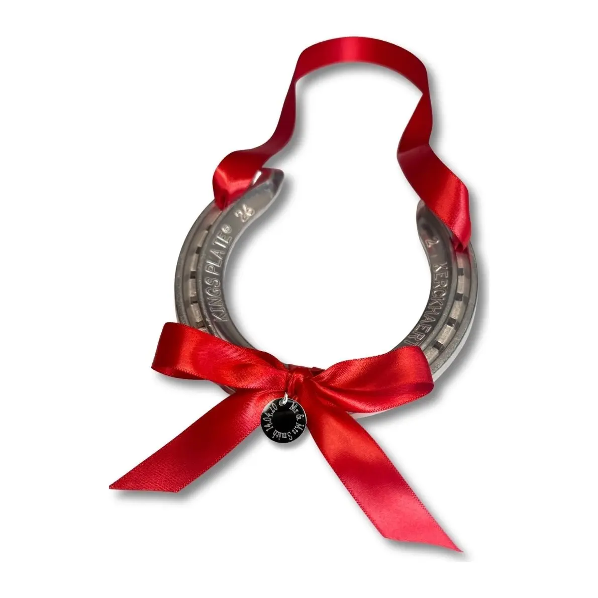 Silver horseshoe with a red ribbon and a round silver engraved disc