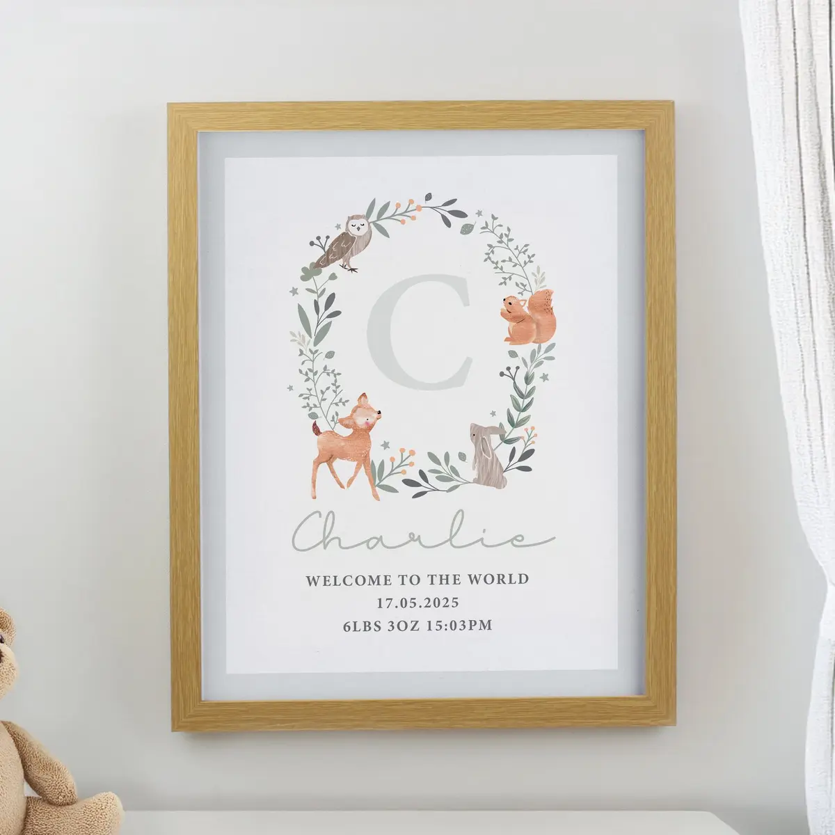 Oak frame with a woodland animal print, a name and an initial
