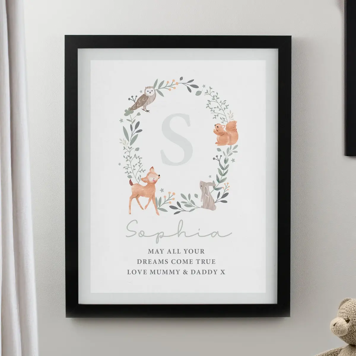 Woodland animal print in a poster frame with a name and an initial