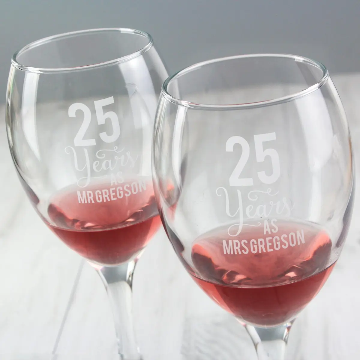 Pair of personalised wine glasses with names and a number of years